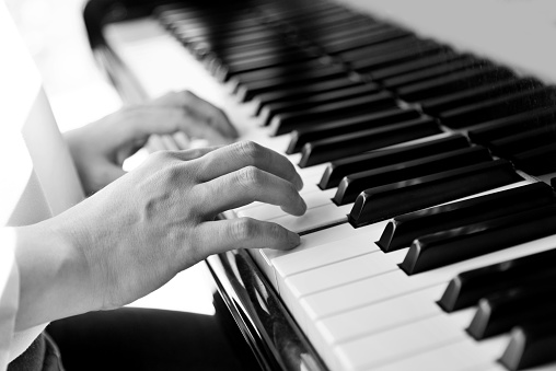 Woman hands playing piano