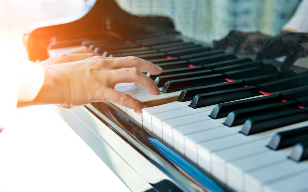 istock Woman hands playing piano 1128936332