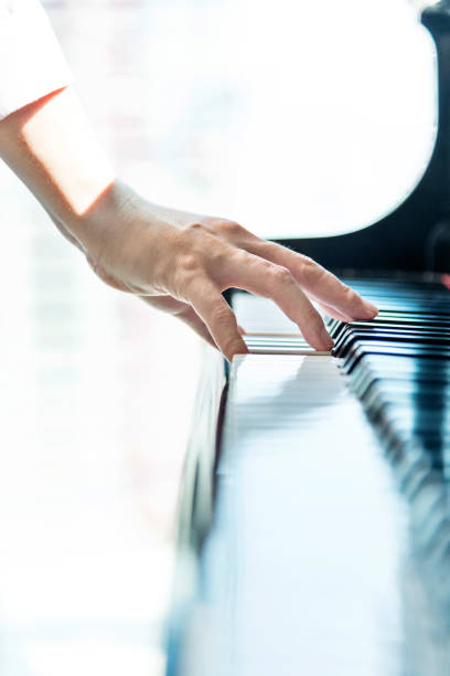 istock Woman hand playing piano 1128936337