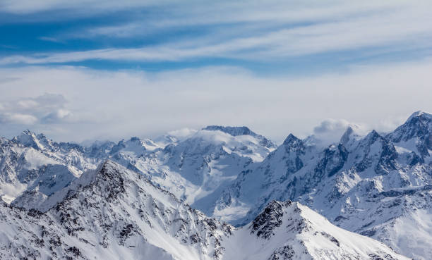 istock Snowy Mountains in blue and white sky 1128938346