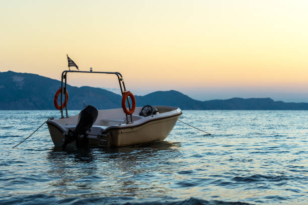istock Small speed boat anchoring in silent water 1128939106