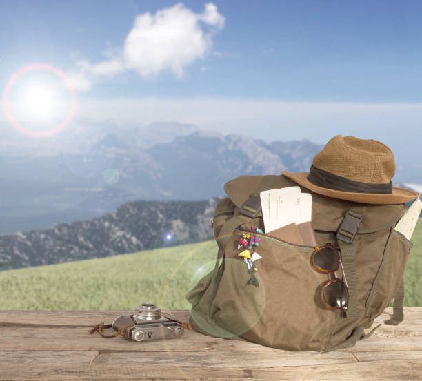 travel concept backpack over wooden table