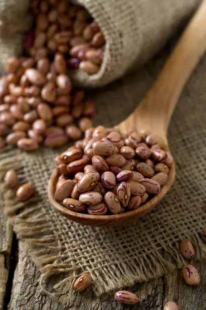 pinto beans on wooden surface