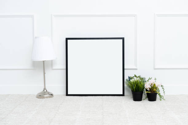 istock There are beautiful flowers and various objects near the rectangle blank picture frame. 1128944548
