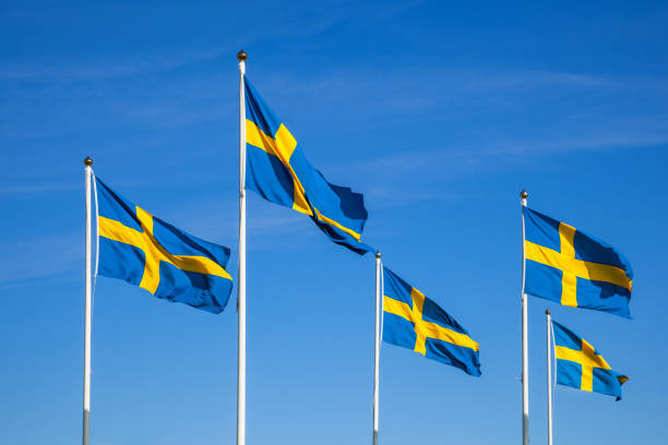 Swedish flags on the national day against a blue sky