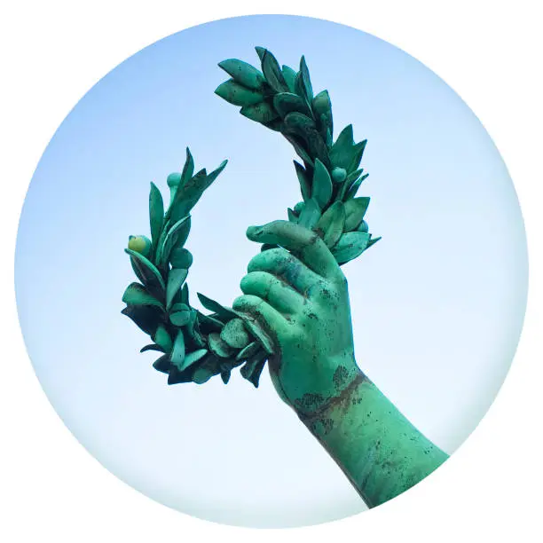 Photo of Hand holds a laurel wreath - bronze statue on colored background - Success and fame concept in round icon shape - Photography in a circle