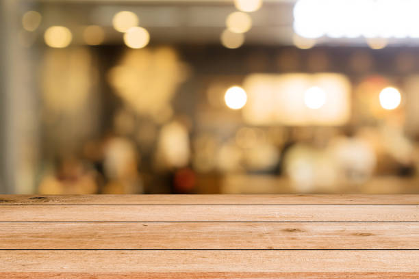 istock abstract blurred modern interior coffee cafe shop decorate with bulbs lamp light on ceiling and wood counter table perspective for show, promote, advertise product o display montage concept 1128947075