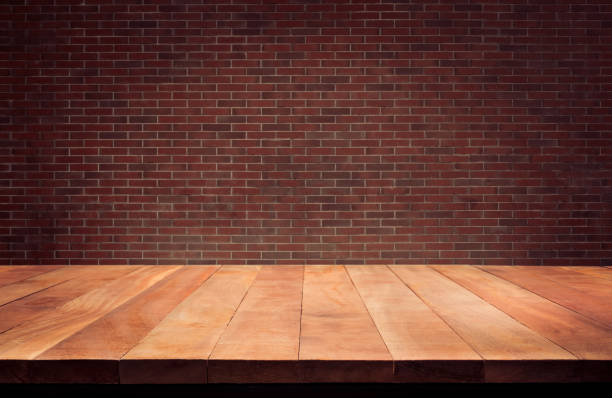 istock Empty wood table top with Brown brick wall background.For create product display or design key visual 1128947099