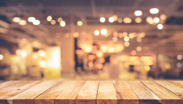 istock Wood texture table top (counter bar) with blur light gold bokeh in cafe,restaurant background.For montage product display or design key visual 1128947574