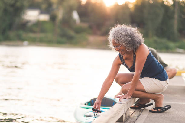 istock A beautiful older woman prepares to go kayaking 1128948390