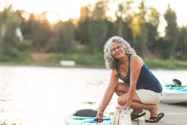 istock A beautiful older woman prepares to go kayaking 1128948394