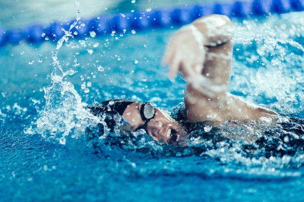 istock Woman Swimming In Pool During Competition 1128948473