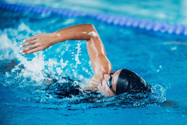 istock Woman Swimming In Pool During Competition 1128948475