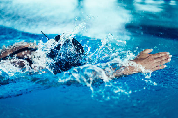 istock Woman Swimming In Pool During Competition 1128948479