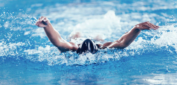 istock Woman Swimming In Pool During Competition 1128948508
