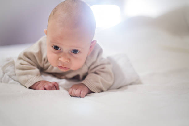 istock Newborn child relaxing in bed. 1128950353