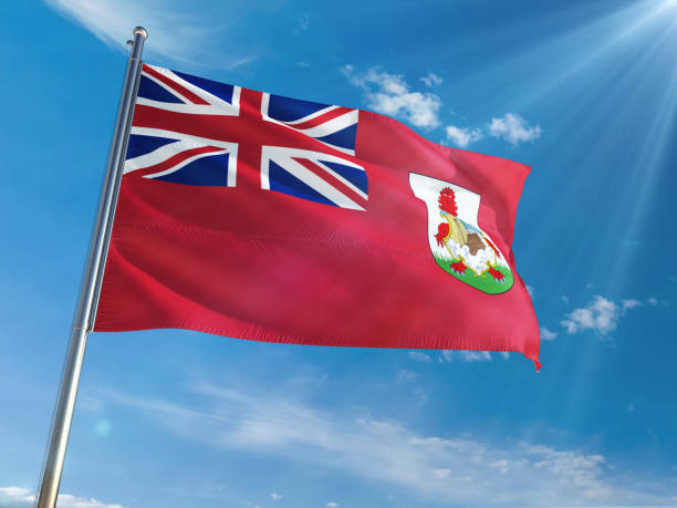 istock Bermuda National Flag Waving on pole against sunny blue sky background. High Definition 1128951228
