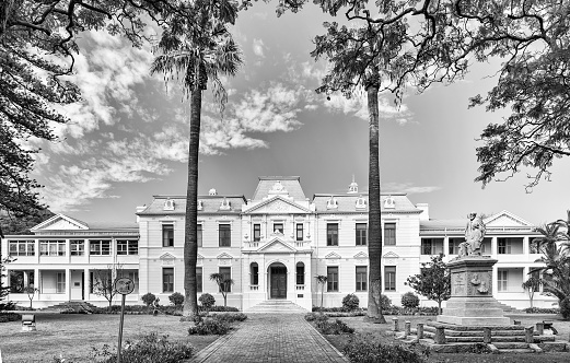 Stellenbosch, South Africa, August 15, 2018: The Faculty of Theology of the University of Stellenbosch. A statue of John Murray and Nicolaas Hofmeyer is visible. Monochrome