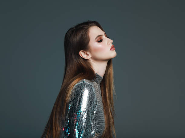 istock Beautiful young woman in sequin top 1128952608