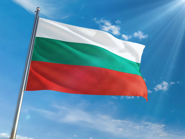 istock Bulgaria National Flag Waving on pole against sunny blue sky background. High Definition 1128953143