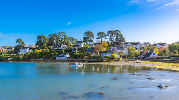 Brittany, Ile aux Moines island Brittany, Ile aux Moines island in the Morbihan gulf, the typical harbor and village, low tide france village blue sky stock pictures, royalty-free photos & images