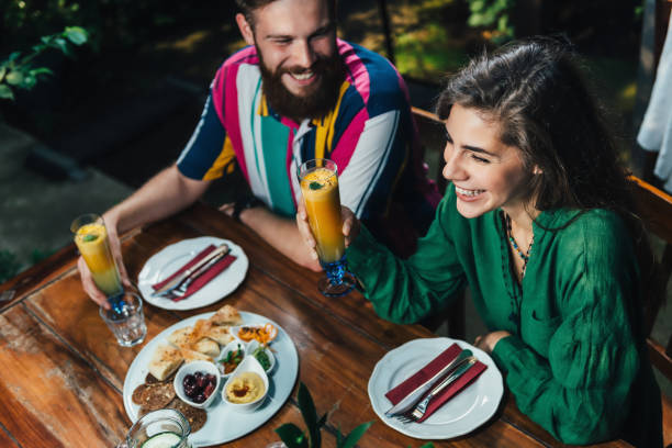 istock High Angle View Of Smiling Young Couple Sitting At Table In Restaurant 1128954502