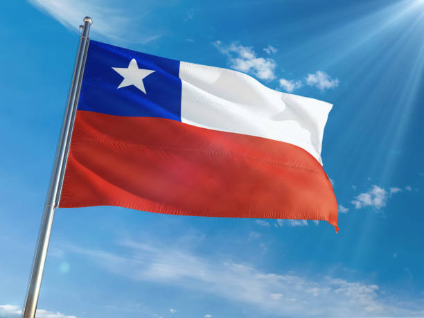 istock Chile National Flag Waving on pole against sunny blue sky background. High Definition 1128954559