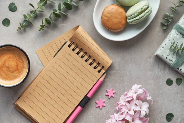 istock Springtime flat lay with pink hyacinth, eucalyptus, mobile phone, notebook, coffee and macarons 1128959507