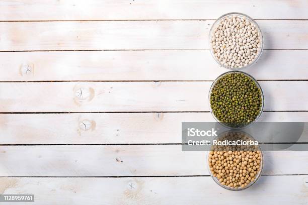 Raw Dry Various Vegetable Protein On White Wood Background Stock Photo - Download Image Now