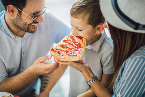 istock Happy family eating in a restaurant 1128960855