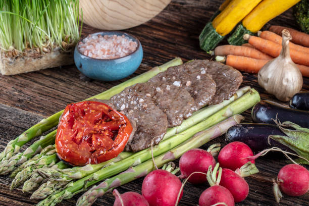 istock Turkish meatballs, (Turkish Food Kofte or Kofta), created background with vegetables, Meatballs on asparagus. 1128960956