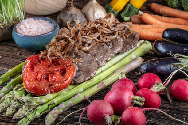istock Turkish meatballs, (Turkish Food Kofte or Kofta), created background with vegetables, Meatballs on asparagus. 1128961374