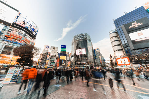 Motion blur of people walking at Shibuya crossing and car traffic transportation across intersection. Asia tourist attraction, Japan tourism, or Asian city life concept Tokyo, Japan - Jan 10, 2019: Motion blur of people walking at Shibuya crossing and car traffic transportation across intersection. Asia tourist attraction, Japan tourism, or Asian city life concept tokyo crowds on the famous shibuya crossing japan stock pictures, royalty-free photos & images