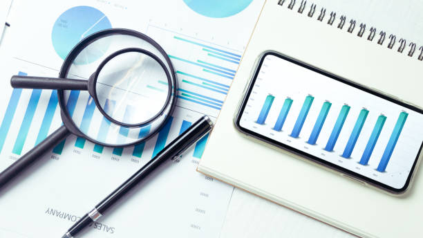 istock Graphs and charts elements on phone screen  and statistical performance of the company. 1128962260