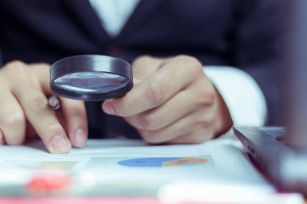 istock Businessmen use a magnifying glass to analyze the company's data and statistics from the chart. 1128962264