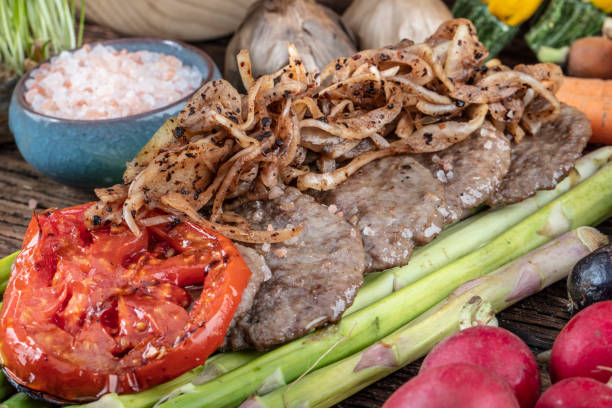istock Turkish meatballs, (Turkish Food Kofte or Kofta), created background with vegetables, Meatballs on asparagus. 1128962274