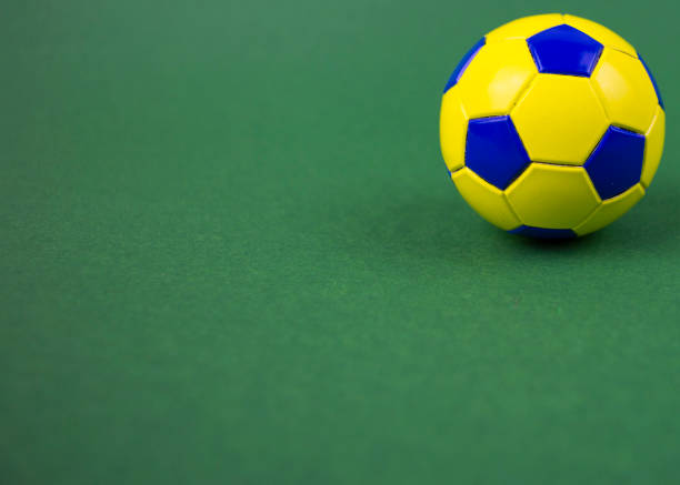 istock soccer ball on a green background, with space for adding text 1128963029