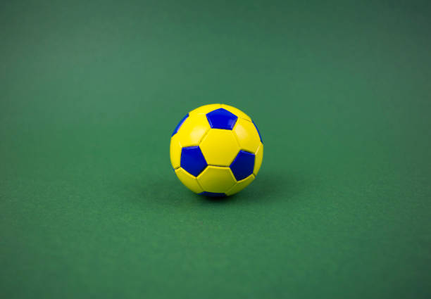 istock soccer ball on a green background, with space for adding text 1128963030