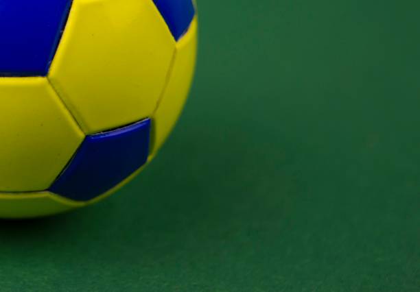 istock soccer ball on a green background, with space for adding text 1128963031