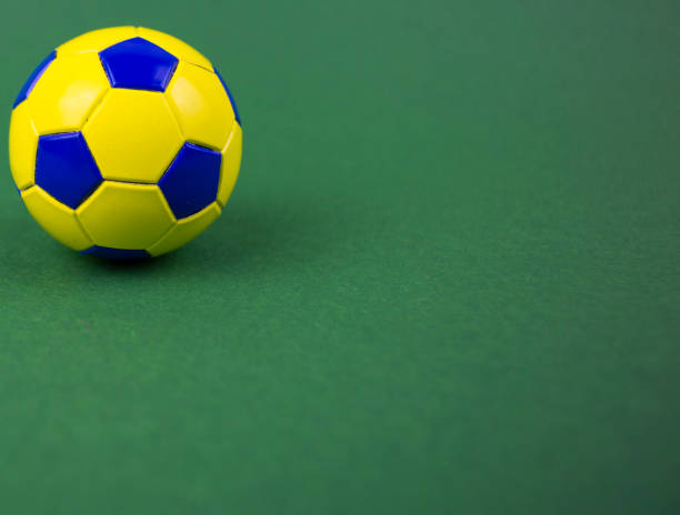 istock soccer ball on a green background, with space for adding text 1128963044