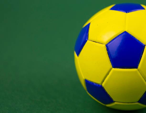 istock soccer ball on a green background, with space for adding text 1128963046