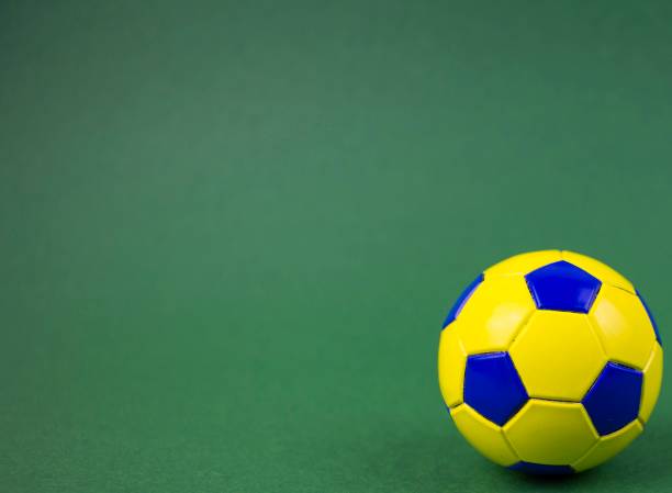 istock soccer ball on a green background, with space for adding text 1128963062