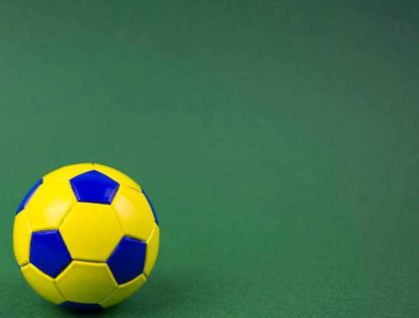 istock soccer ball on a green background, with space for adding text 1128963064