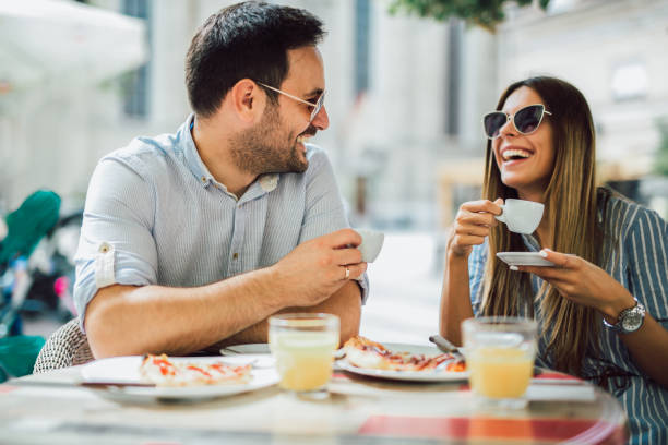 istock Couple eating pizza snack outdoors 1128963127