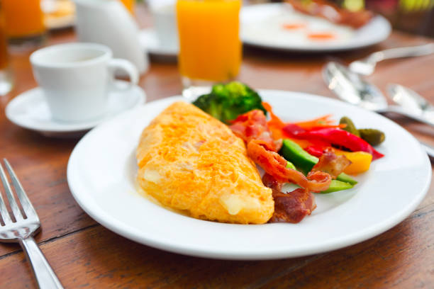 istock Omelet with pepper, cucumber, bacon and salad on the table 1128963323