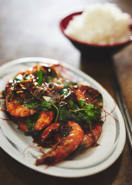 istock Prawns, green vegetables and white rice. 1128963876