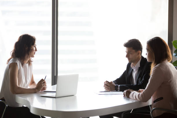 istock Diverse business people communicating sitting at office meeting table 1128967588