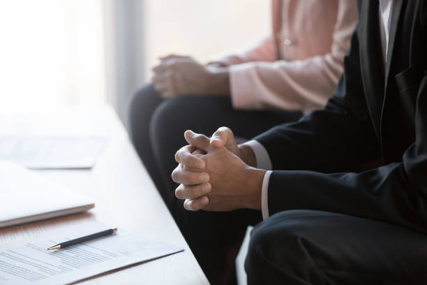 istock Businessman with clasped hands negotiating about contract at group meeting 1128967616