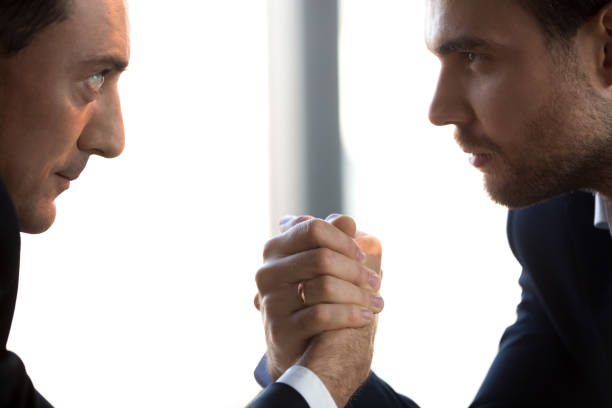 dos empresarios confío en compiten vencidas en ojos, primer plano - conflict competition arm wrestling business fotografías e imágenes de stock