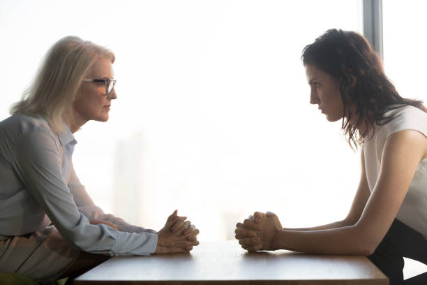 istock Young and old businesswomen sitting opposite, generations conflict at work 1128967642